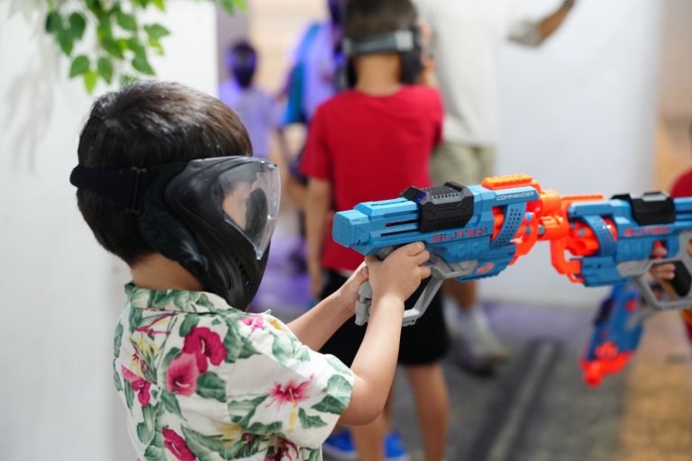 Kids enjoying nerf wargame with friends